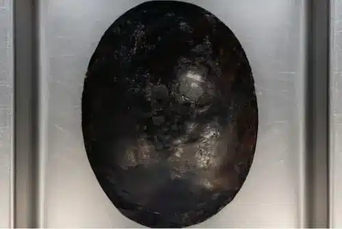 Close-up View of the Black Stone (Hajar al-Aswad) Detailed top view of the Black Stone (Hajar al-Aswad) showing its dark worn texture
